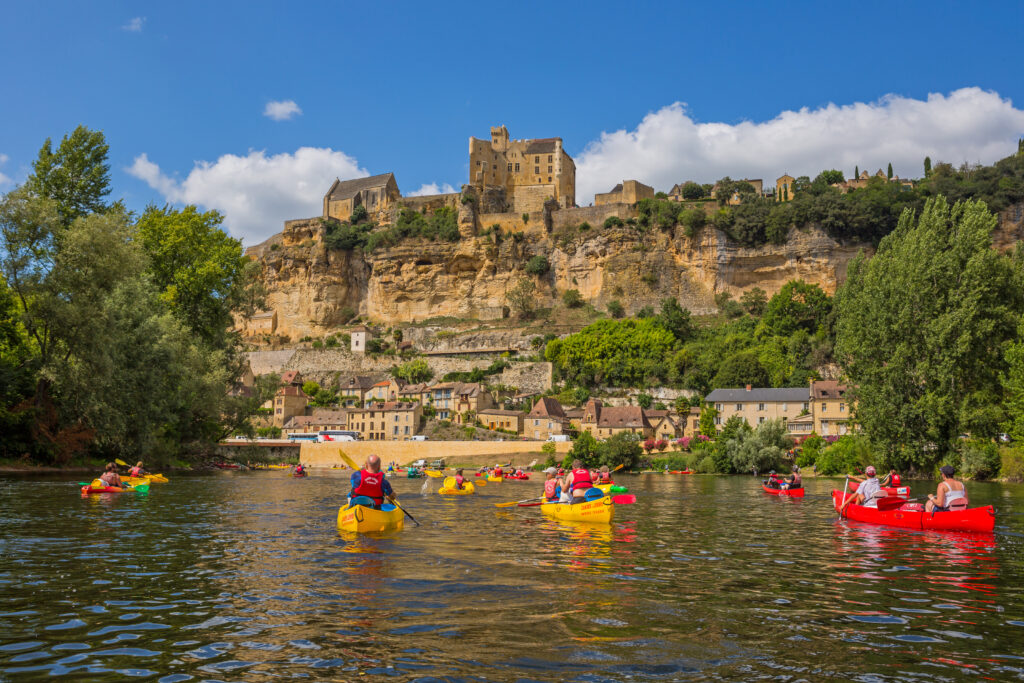 Beynac et Cazenac, Dordogne, France: kayaking on the Dordogne River with the Castle of Castelnaud-la-Chapelle.