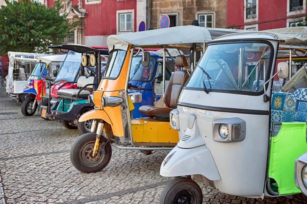 Portugal Travel Ideas. Tuk Tuk in Streets of Lisbon in Portugal as Public Mean of Transport in Open-Air City For Holidays Tourist Destinations