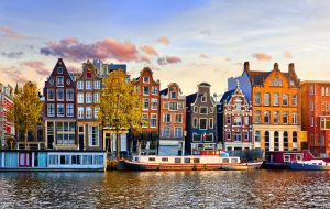 Amsterdam Netherlands dancing houses over river Amstel landmark in old european city spring landscape.