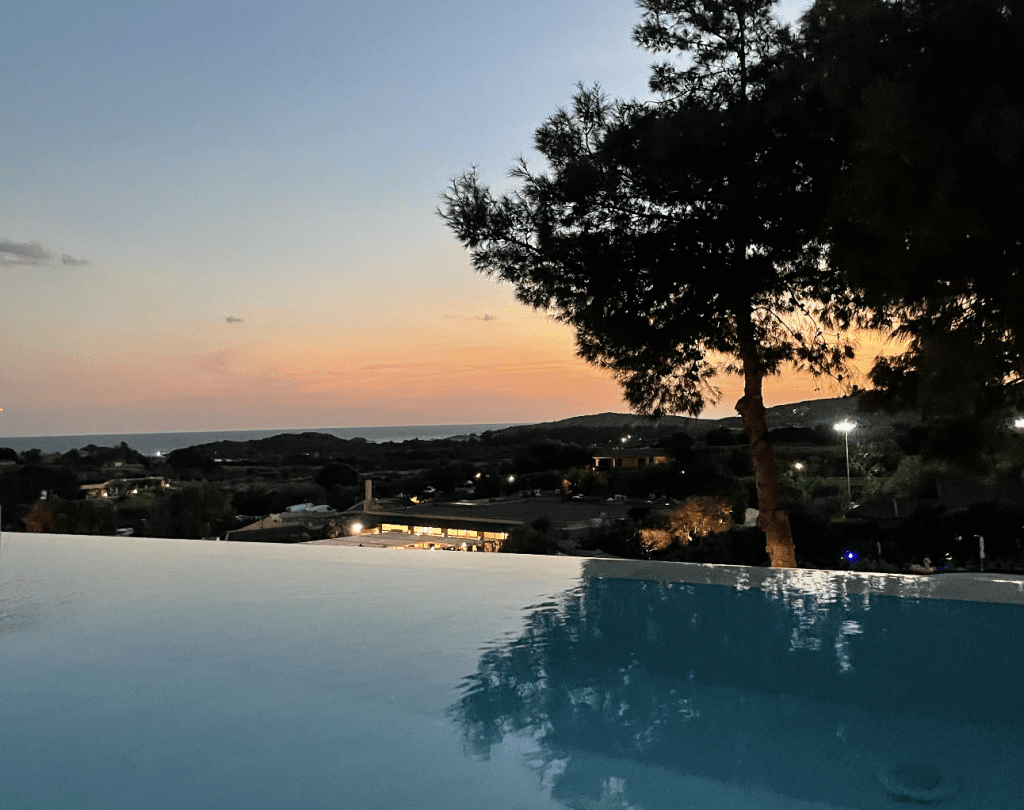 Pool with sunset view over a city.