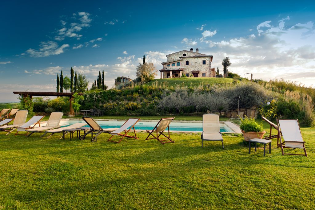 House in Tuscany on a hill with pool and pool chairs