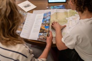 Travel planning with map, two woman in a meeting.