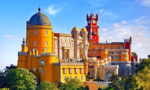 Palace of Pena in Sintra. Lisbon, Portugal. Famous landmark. Summer morning landscape with blue sky.