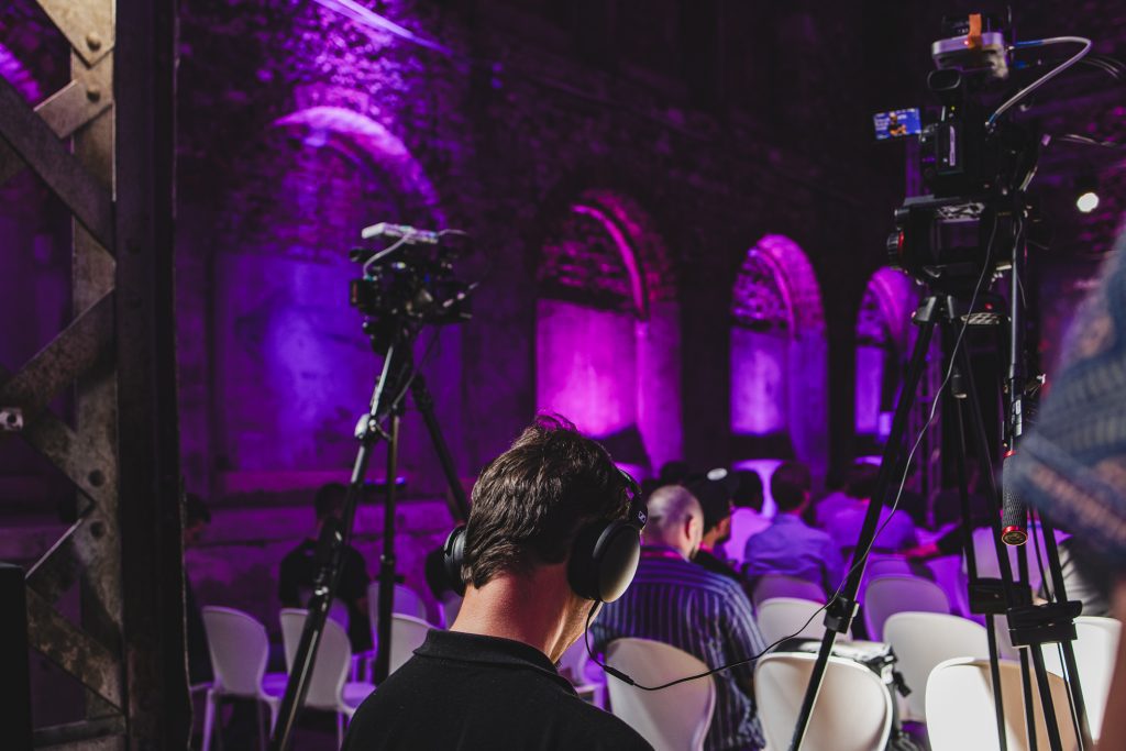 Event location with purple light and camera man.