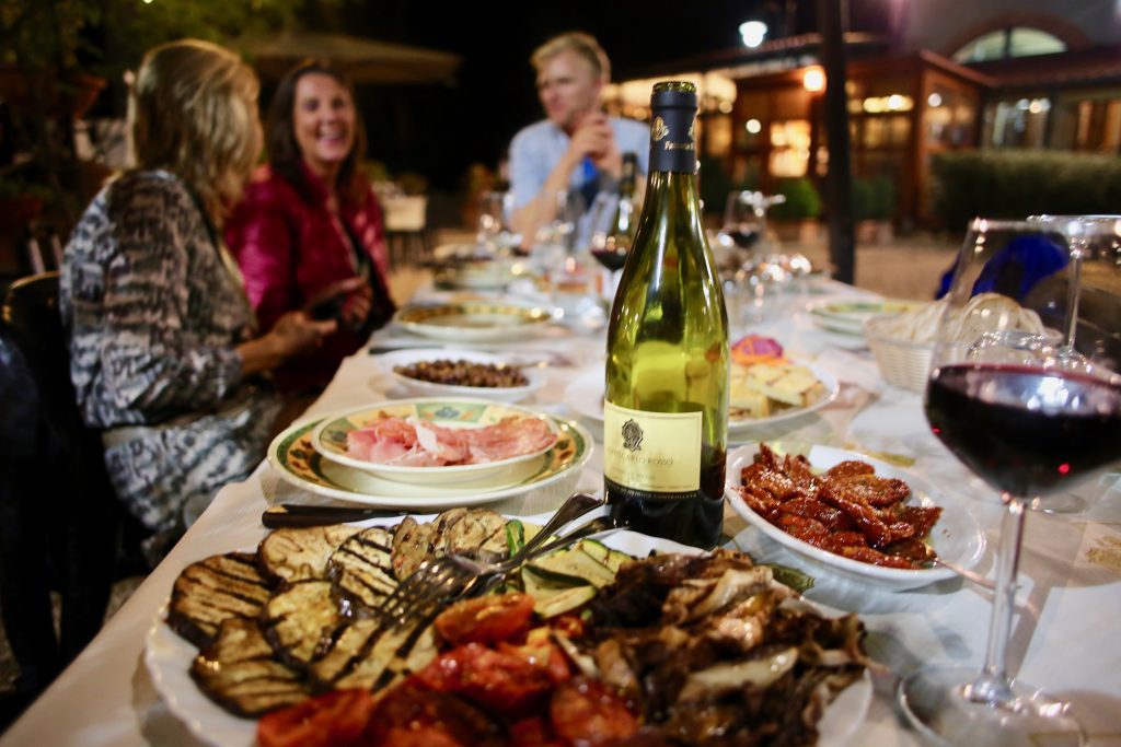 Dinner with Wine and three people at the table.