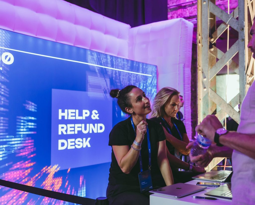 Two woman at hospitality desk, guets managament at conference.