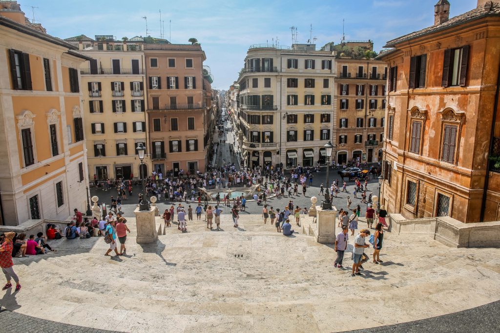 Spanish Steps in Rome with sunshine and many tourists.