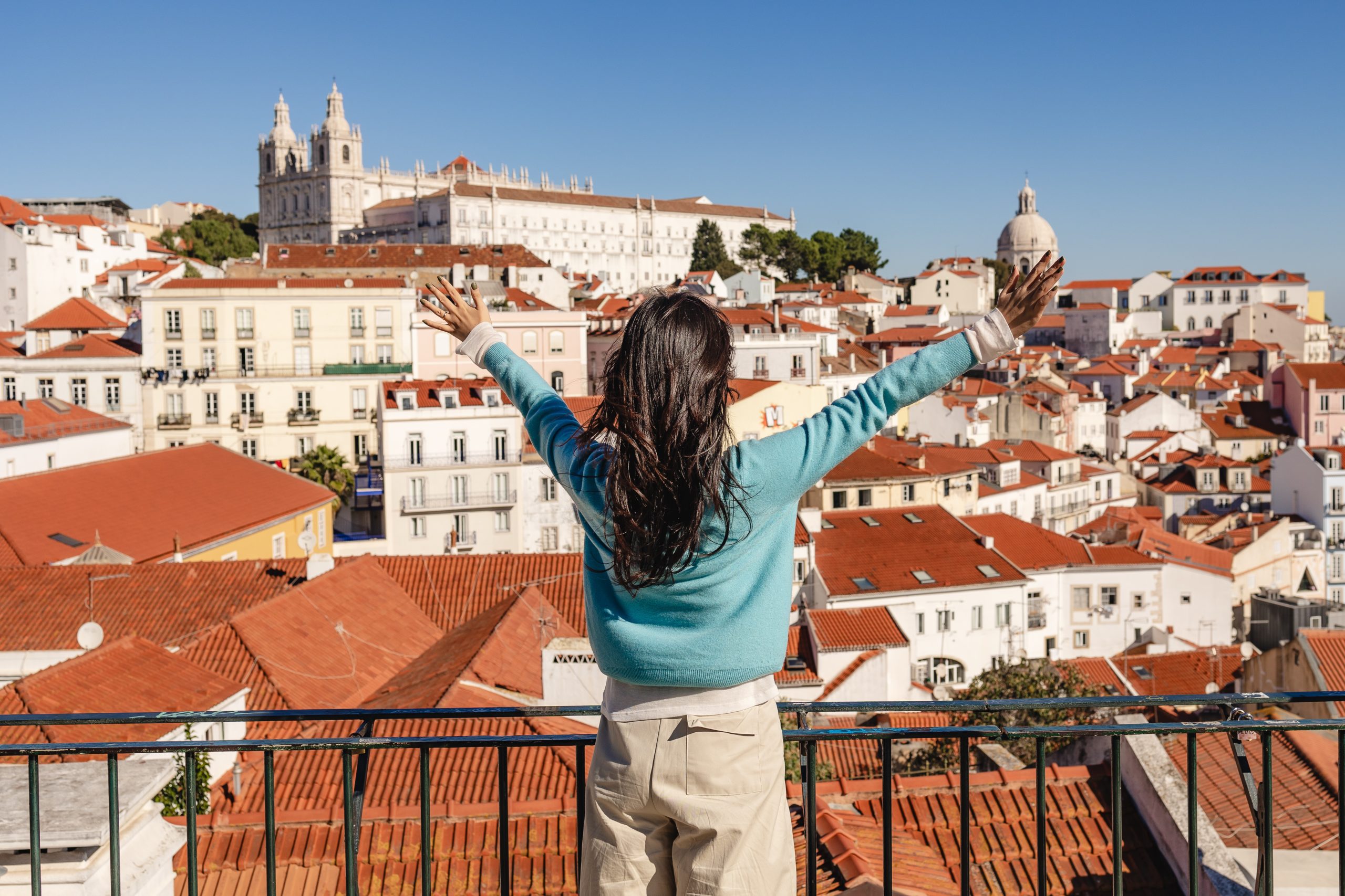 Happy Woman with outstretched arms, viewpoint in Lisbon City.