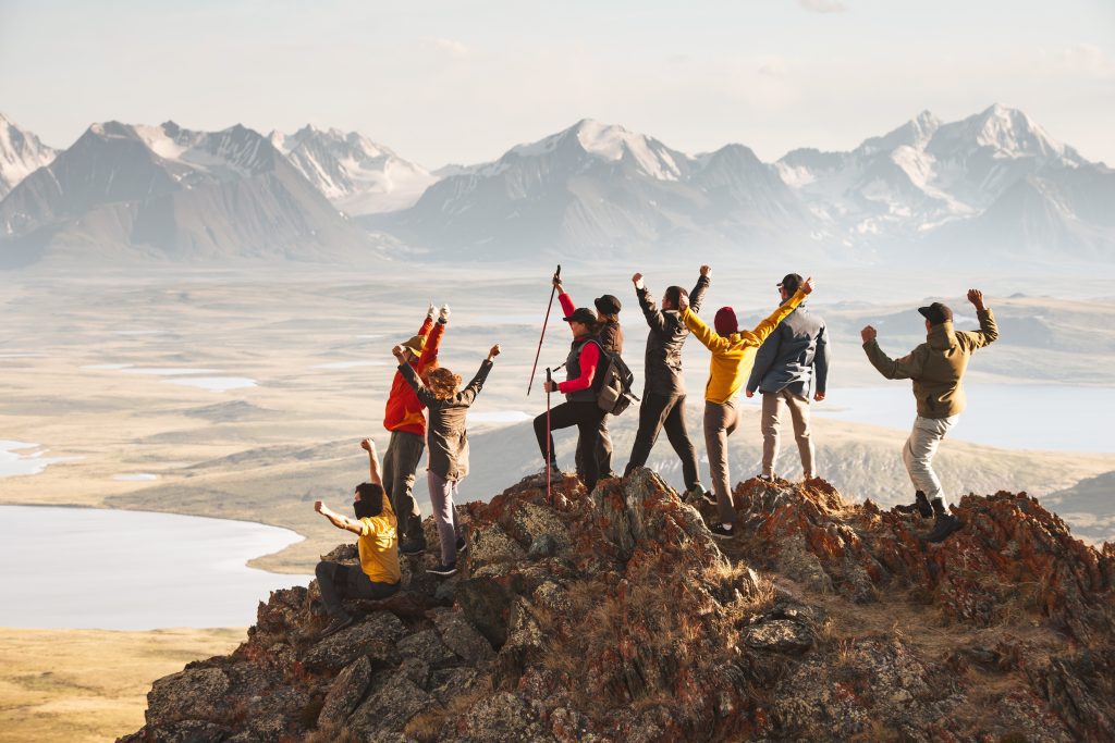 Group of people on the top of a mountain, hiking.