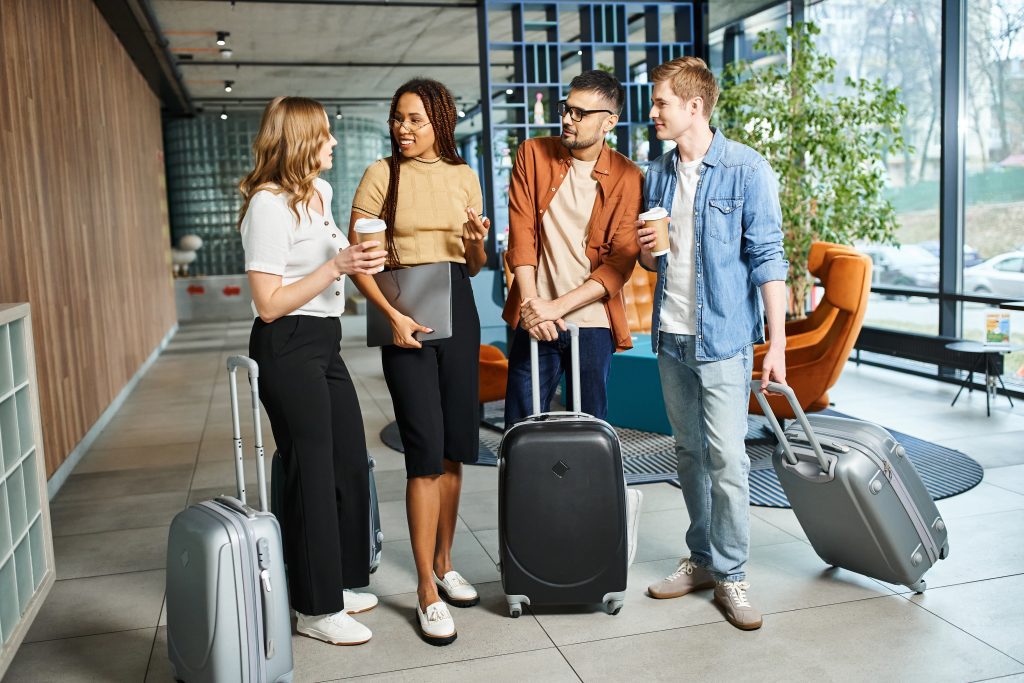 Team travel, group of 4 people with suitcases and laptop