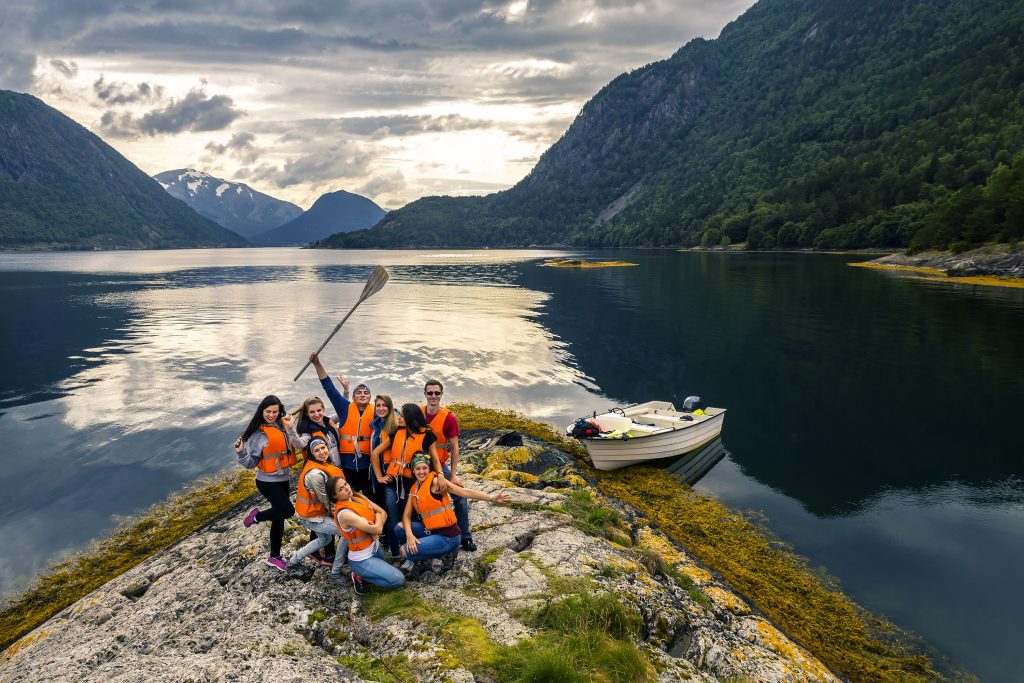 Team outdoor activity by a lake with a boat.