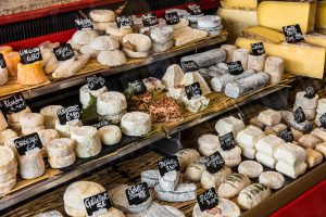 Large selection of different french cheeses at market