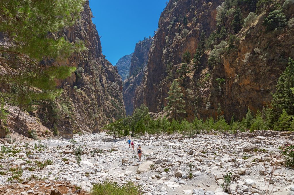 The famous Samaria Gorge in the White Mountains of Crete, featuring dramatic cliffs, rocky trails and stunning natural scenery.