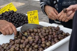 Traditional olive market in Crete, Greece, displaying fresh olives and local olive varieties from the Mediterranean region.