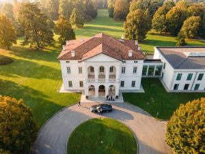 Aerial view of a countryside villa hotel with manicured gardens and trees near Bologna, Italy