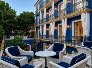 Blue-and-white tiled boutique hotel terrace in Lisbon with a small table and views over the city rooftops