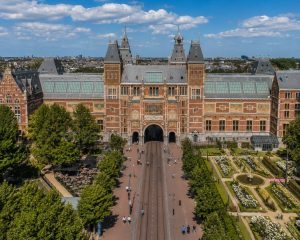 Elevated view of the Rijksmuseum in Amsterdam with formal gardens and pathways leading to the entrance