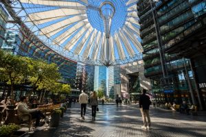 Glass canopy of the Sony Center at Potsdamer Platz with people crossing the plaza below