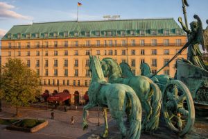 Historic grand hotel facade in central Berlin with sculptural topiary in the front garden