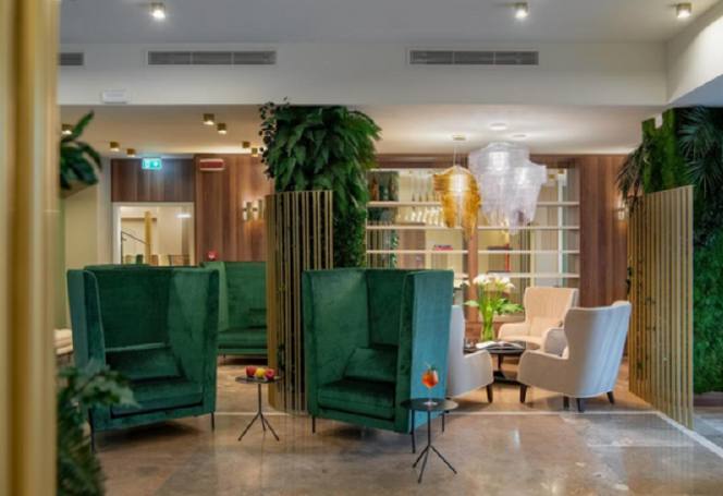 Hotel lounge with green velvet armchairs for breakout sessions