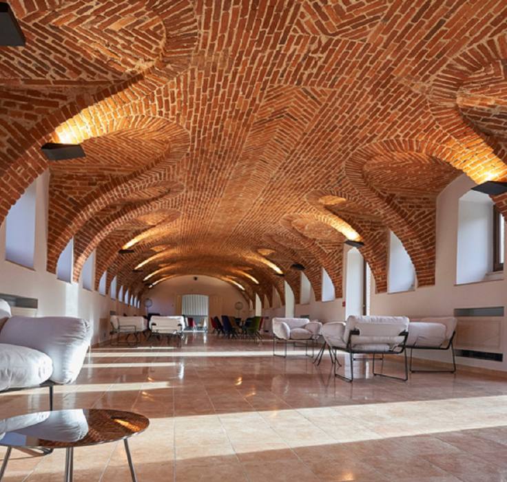 Vaulted brick meeting room in a restored countryside relais