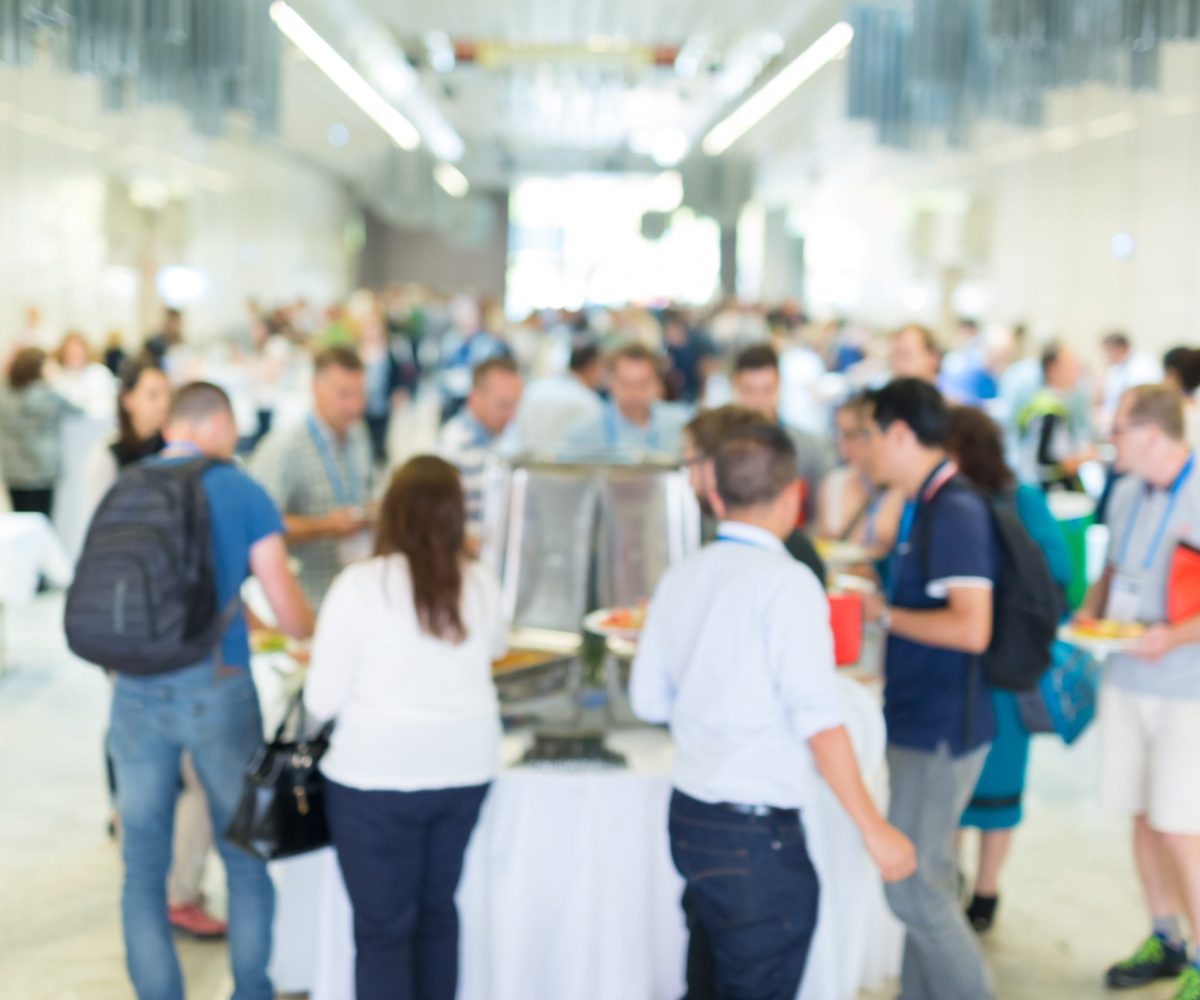 people socializing during lunch break at business conference.